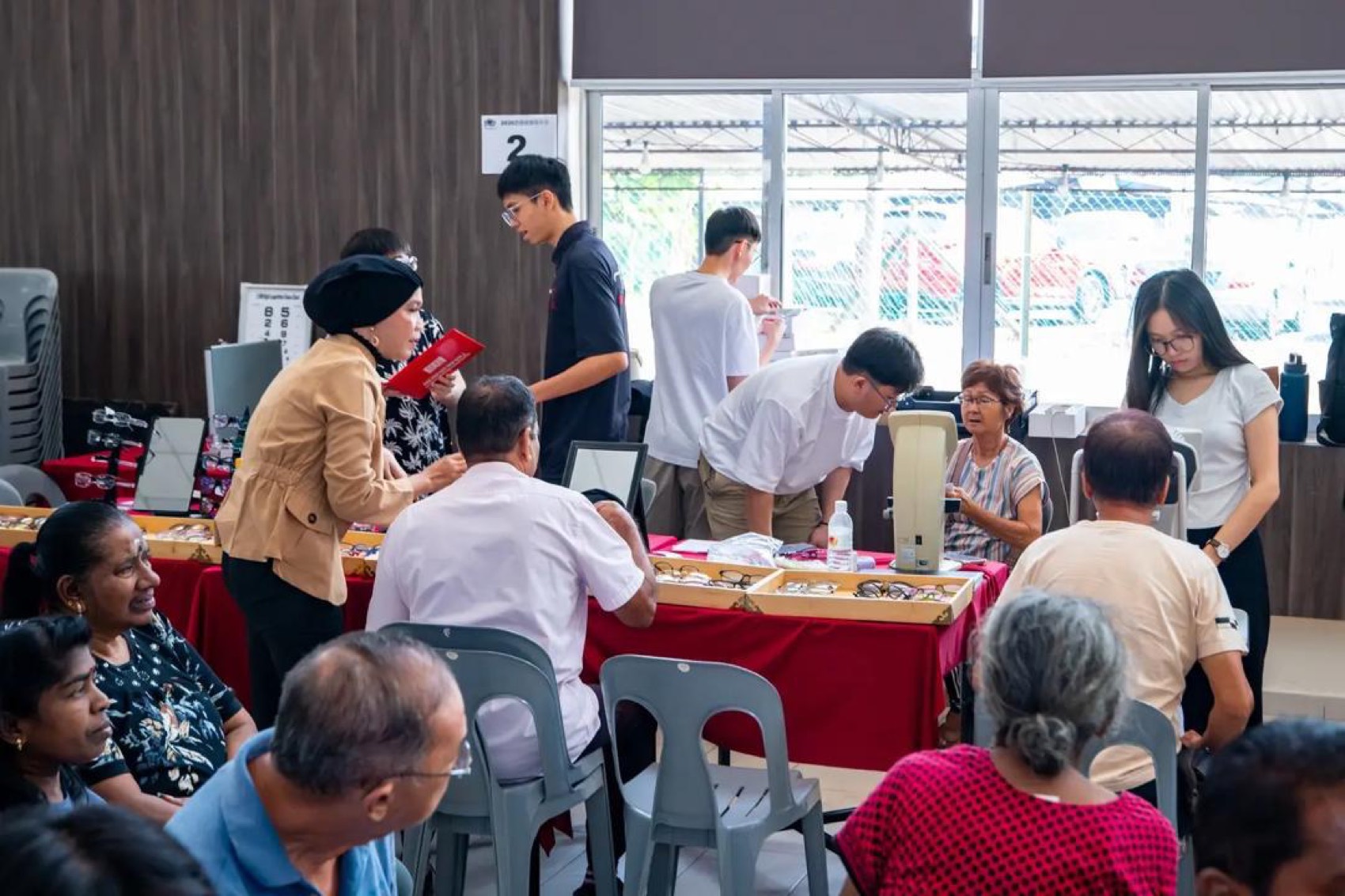 Residents being fitted with spectacles at the Bukit Mertajam welfare drive